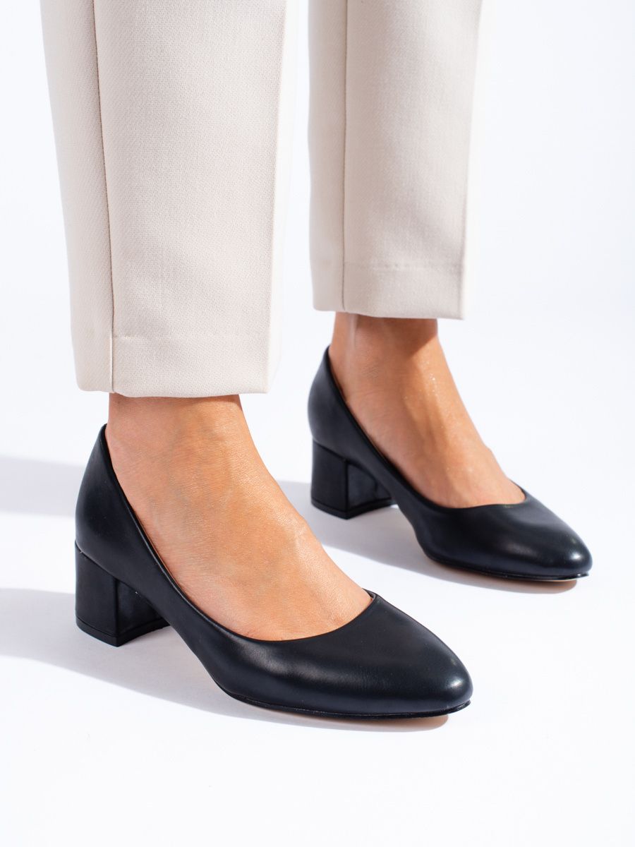 Black pumps on a low post made of Shelvt leatherette