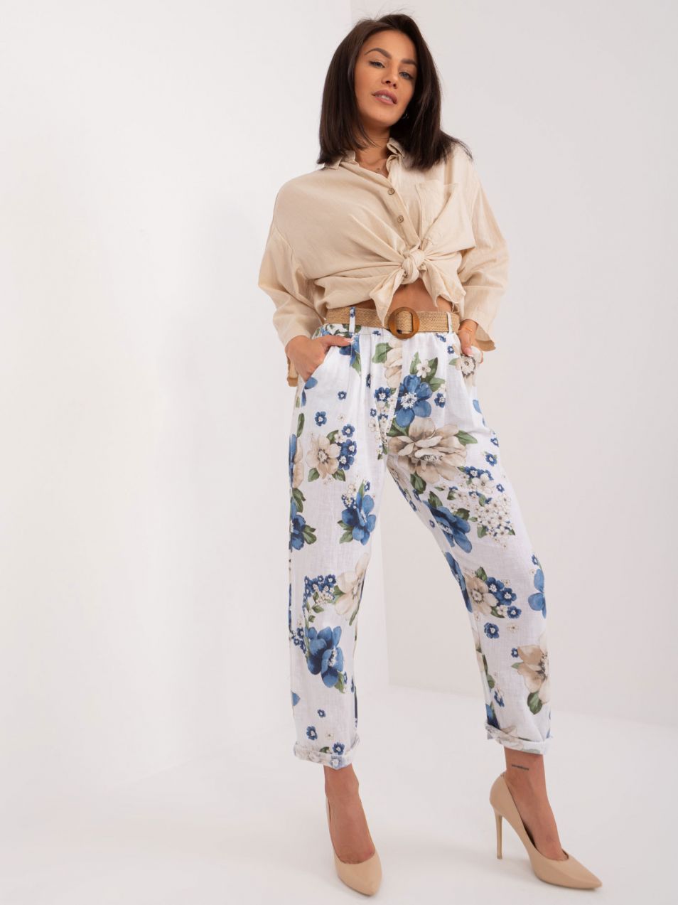 White women's fabric trousers with flowers