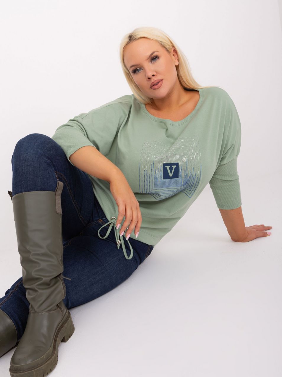 A pistachio blouse in a larger size with rhinestone appliqué