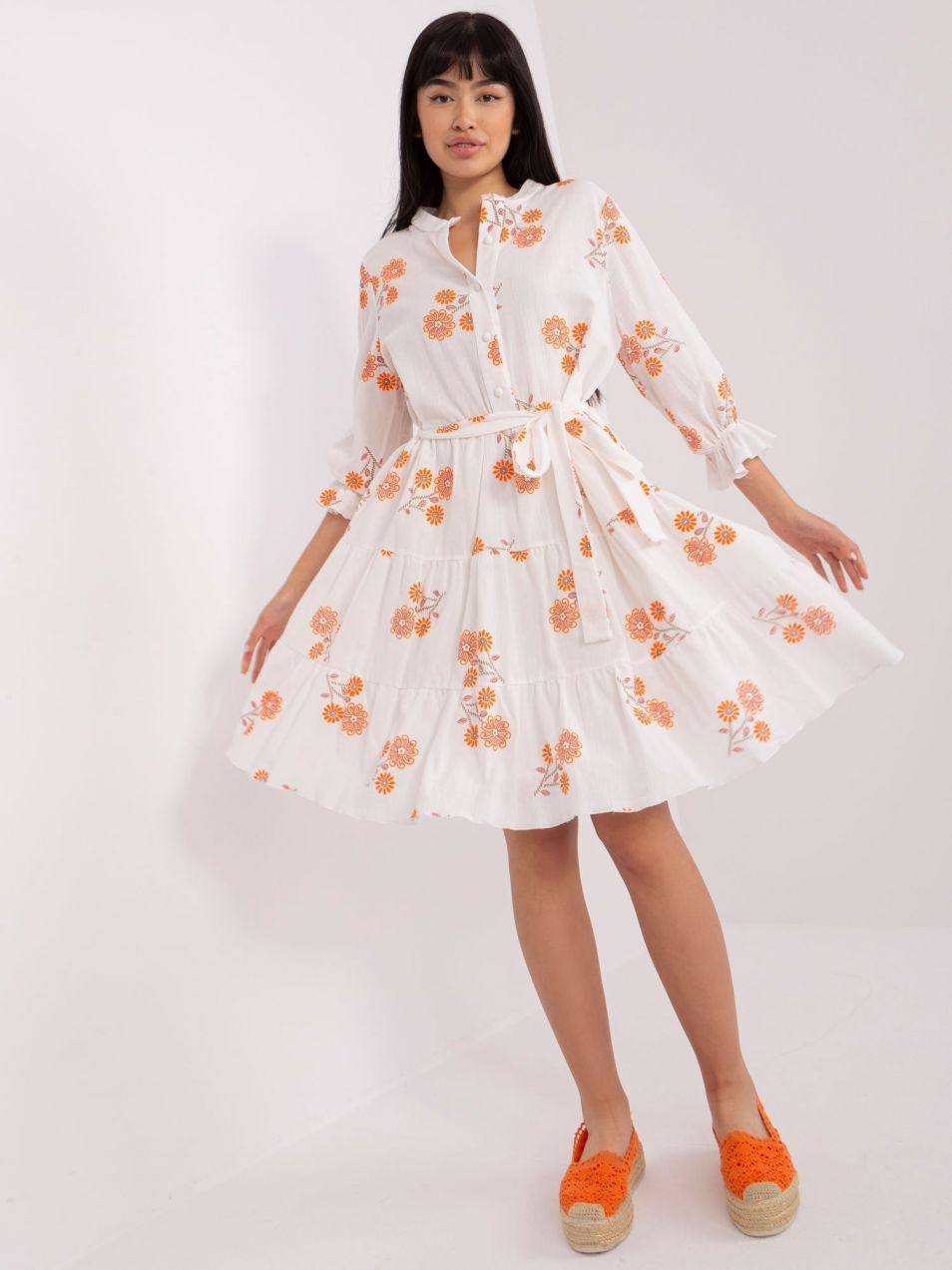 White and orange patterned dress with frill