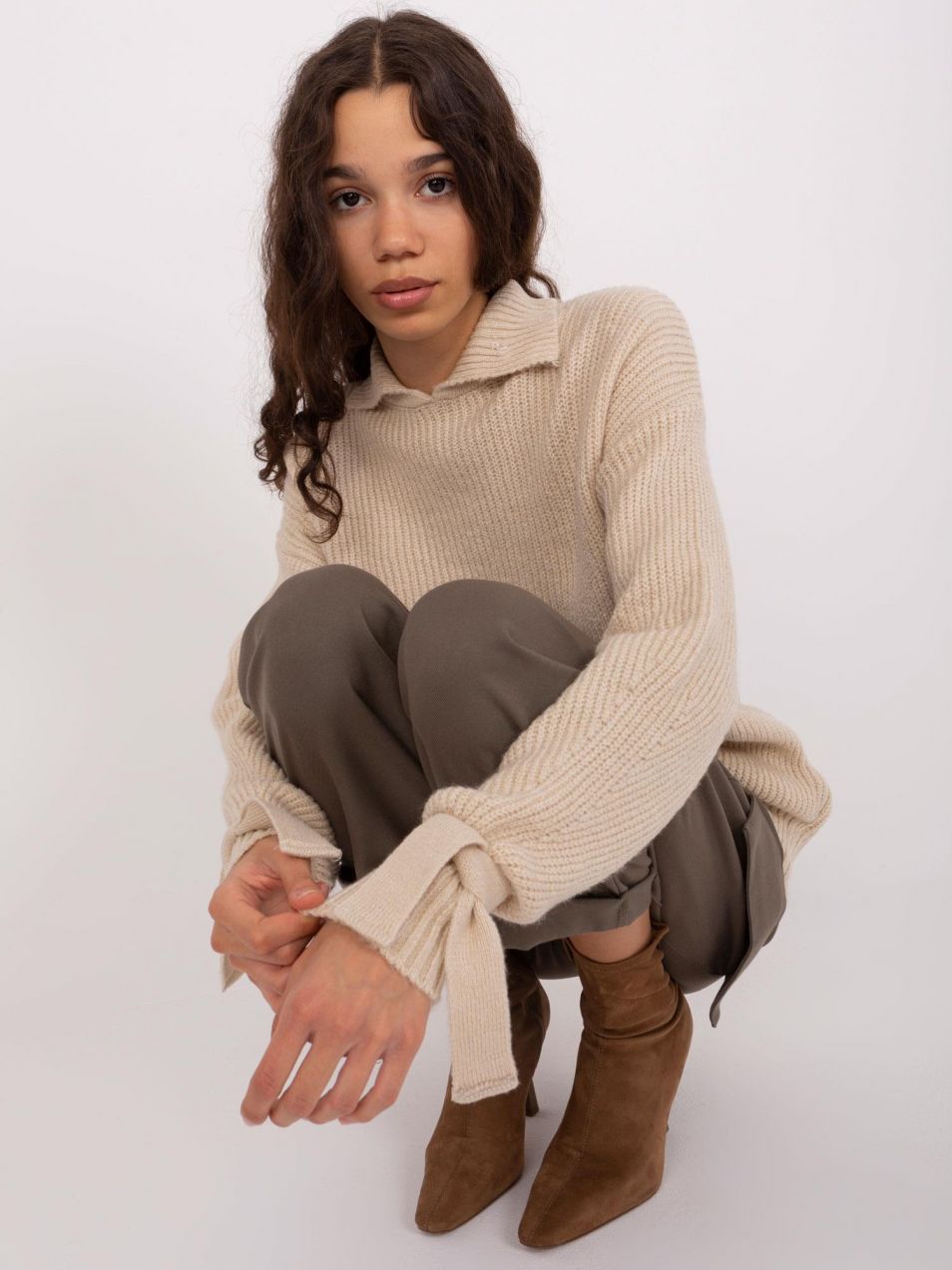 Beige turtleneck with ties on the sleeves