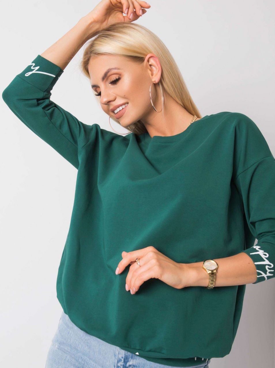 Dark green sweatshirt with lettering on the cuffs