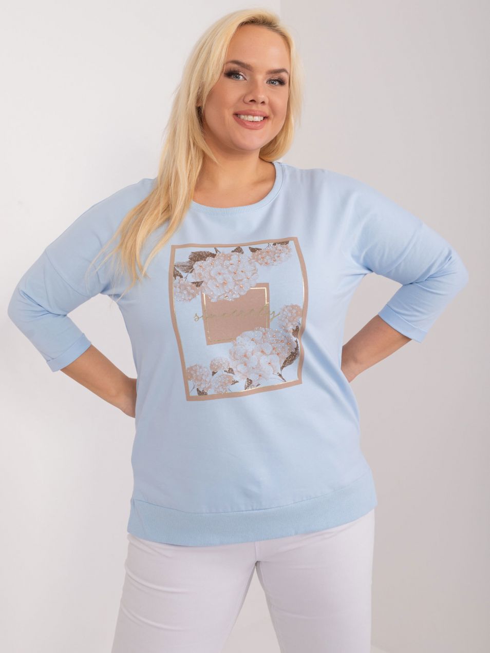A light blue plus-size blouse with slits