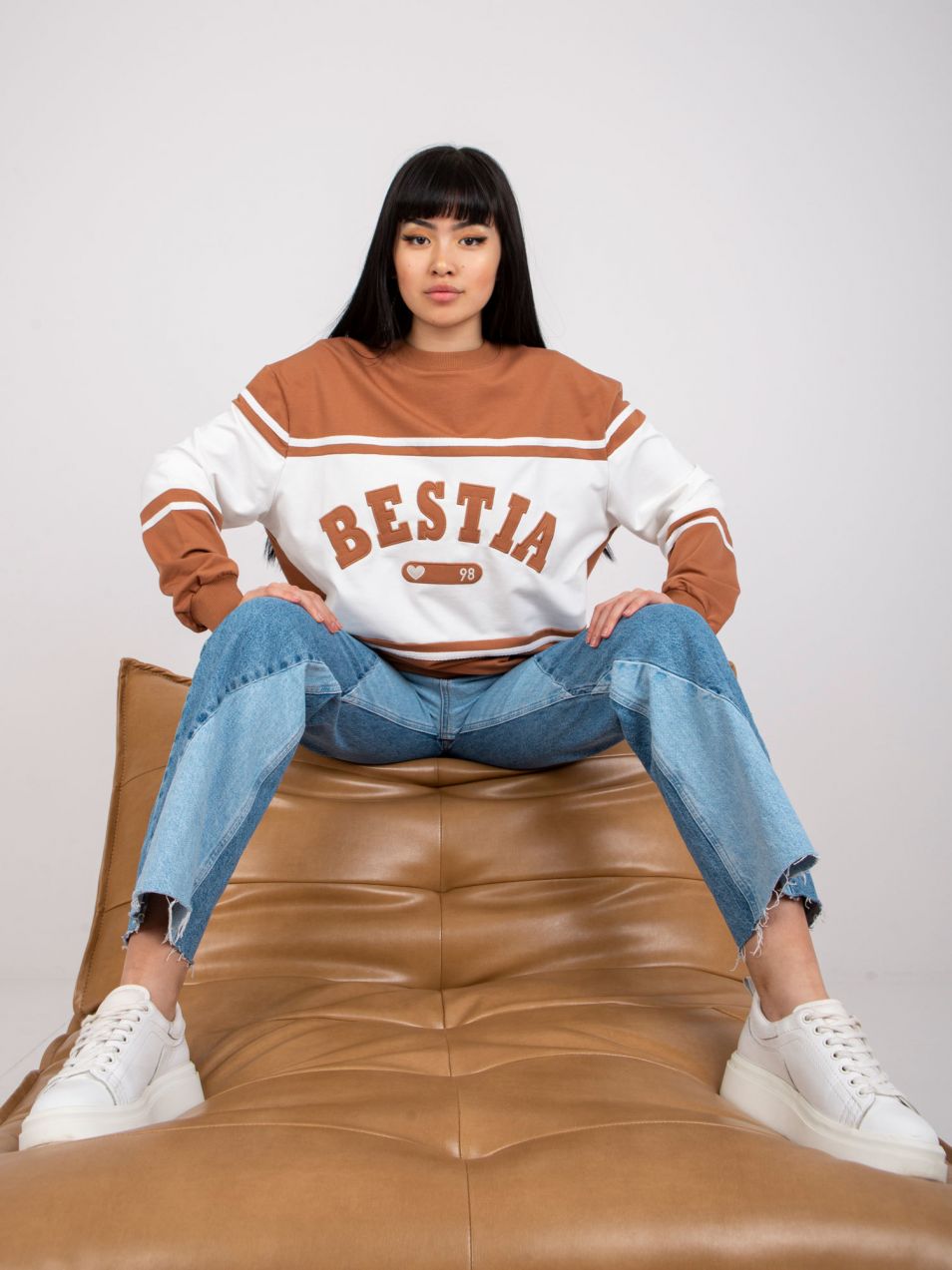 Brown-and-white hoodie with inscription