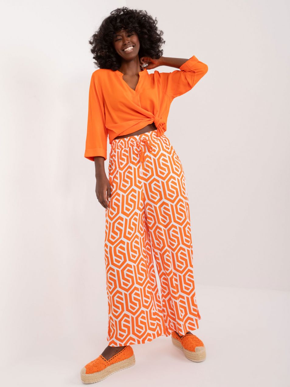 Orange wide trousers with SUBLEVEL print