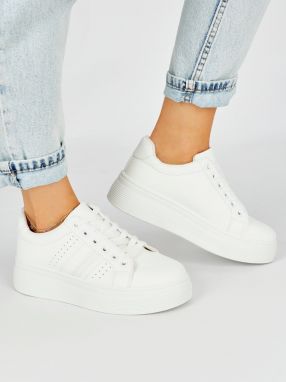 Shelvt White sports sneakers on a platform